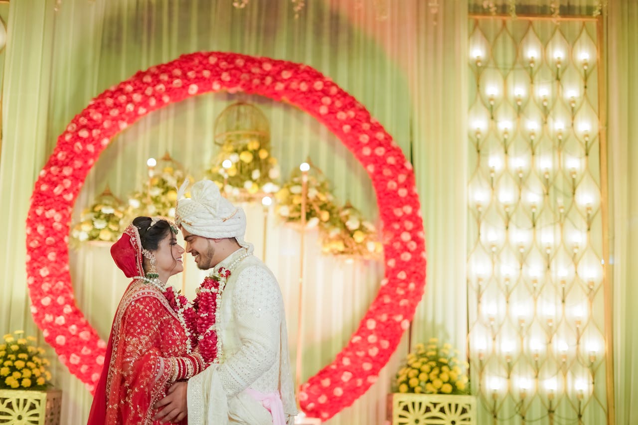 A vibrant Indian wedding in Delhi showcasing a bride and groom in traditional attire surrounded by floral decor.